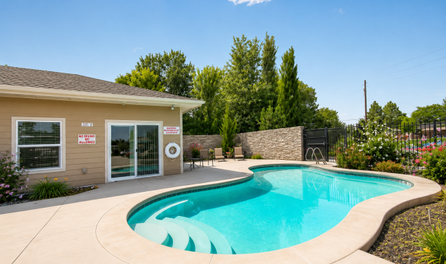 Resort-style swimming pool with lounge seating