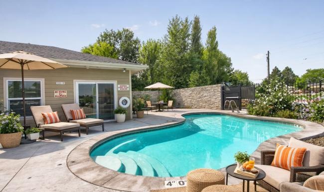 Resort-style swimming pool with lounge seating